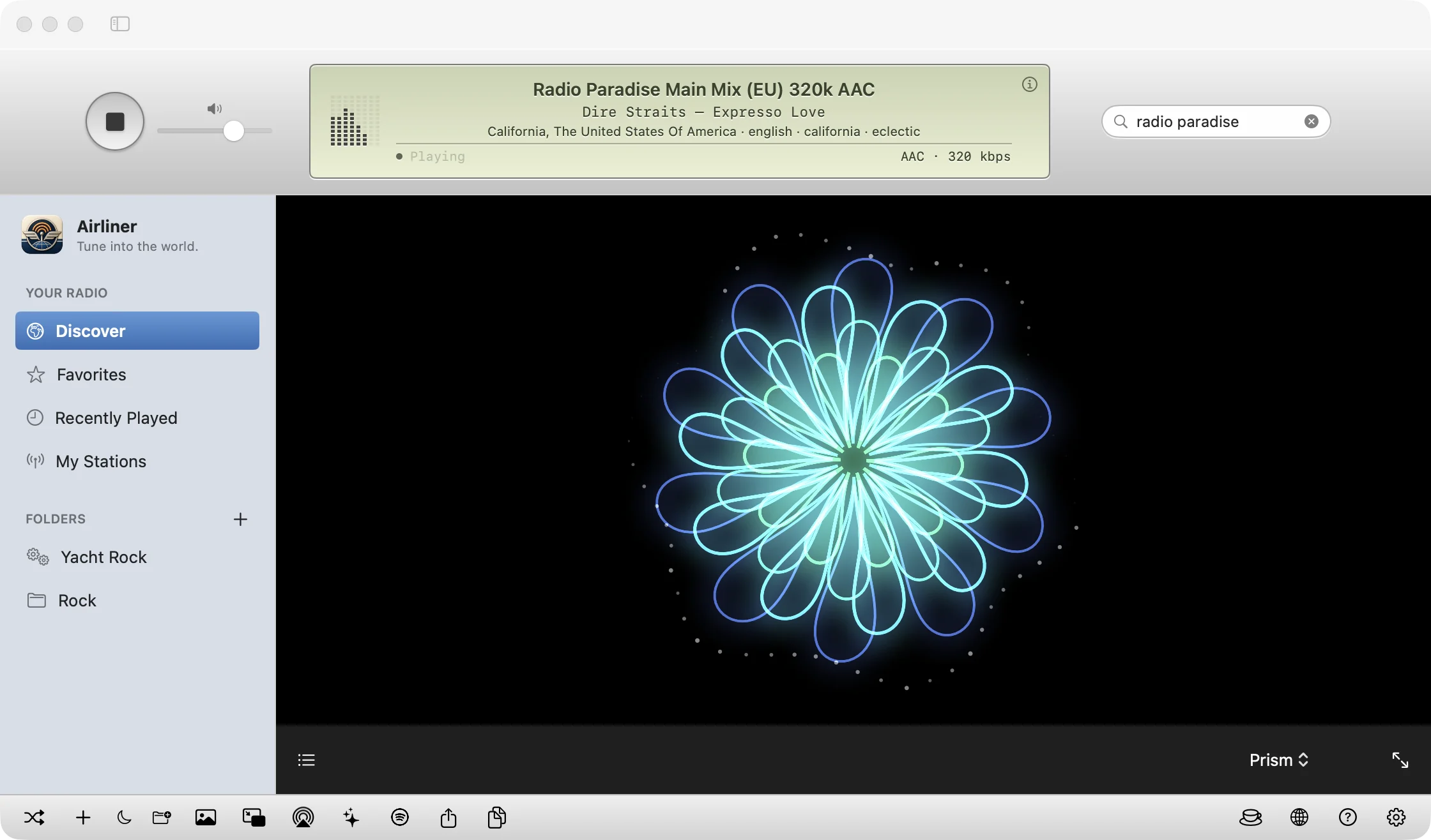 Airliner's Prism visualizer filling the main window with layered glowing kaleidoscope petals while a station plays